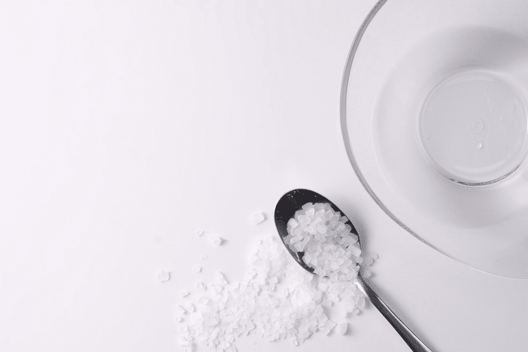 Salt in Spoon with Bowl of Water