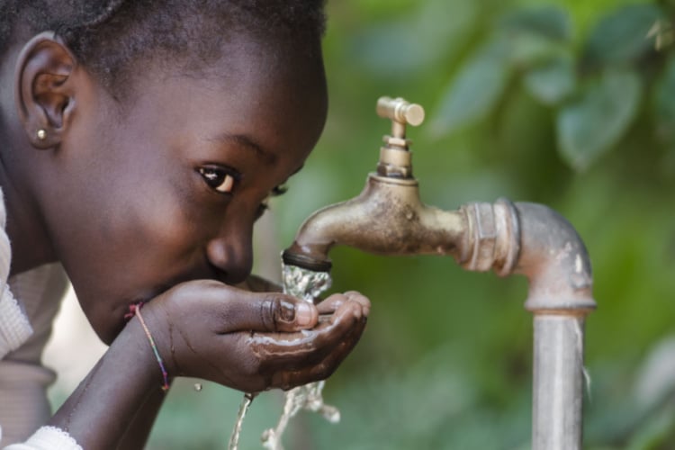 Child drinking tap water in Nigeria