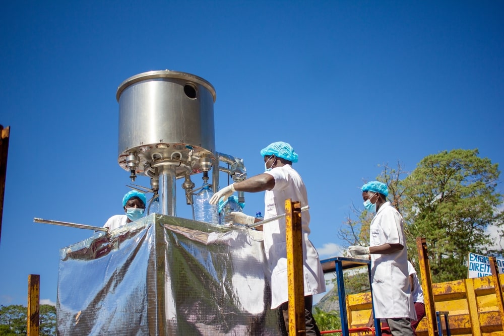 Workers Handling Mineral Water Filter in Mozambique