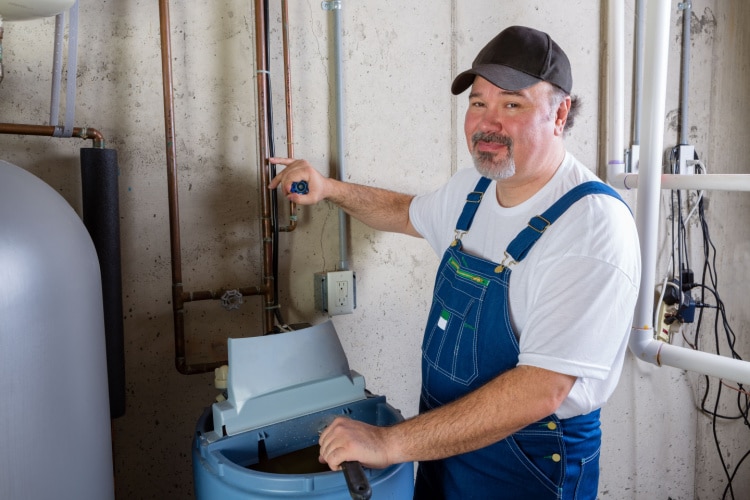 Man maintenaning a Water Softener 